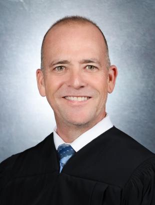 Circuit Judge Keith A. Carsten