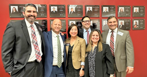 A group of Ninth Circuit Judges who are alumnus of Barry University Law School standing in front of the school's Judicial Excellence Wall of Fame.